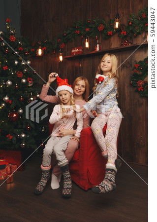 Merry Christmas and Happy Holiday Mom and daughter decorate the Christmas Merry Christmas and Happy Holiday Mom and daughter decorate the Christmas 59443047