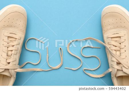 Sneakers with laces in suss text. Detective concept Sneakers with laces in suss text. Detective concept 59443402