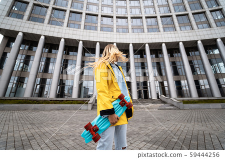 Beautiful blonde woman posing with a skateboard Beautiful blonde woman posing with a skateboard 59444256