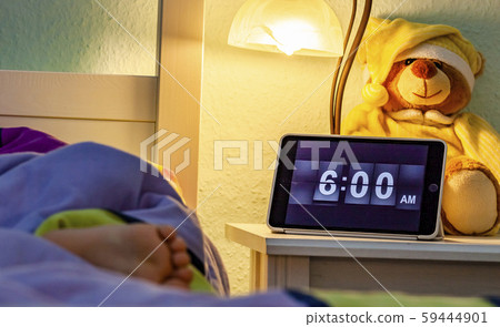 Little girl sleeping in bed - Alarm clock at 6 am in the morning. Little girl sleeping in bed - Alarm clock at 6 am in the morning. 59444901