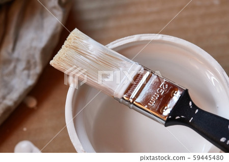 Paint brush on a can of white wall paint 59445480