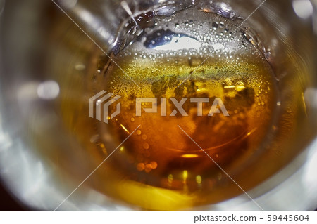 Drinking beer closeup inside the pint glass 59445604