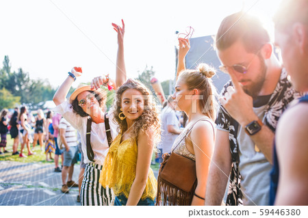 Group of young friends dancing at summer festival. 59446380