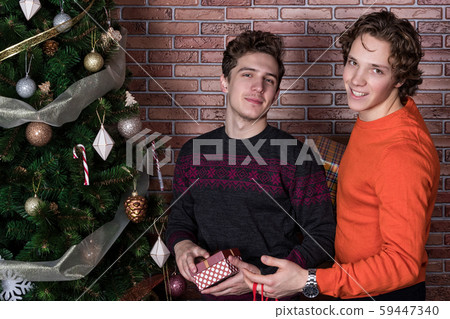 Two funny young men celebrating christmas isolated 59447340