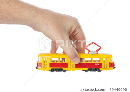 Hand with toy tram 59449096