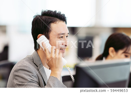 A man who takes a phone call 59449653