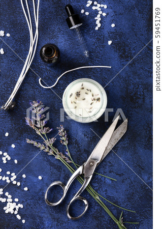 Handmade lavender scented candle with essential oil, flowers, wax, wicks, and scissors, flat lay Handmade lavender scented candle with essential oil, flowers, wax, wicks, and scissors, flat lay 59451769