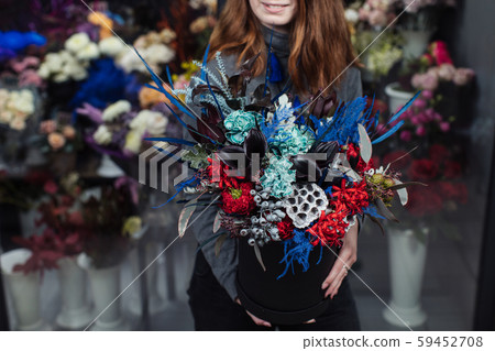 Beautiful bouquet of mixed flowers with peonies. The work of the florist. Flower delivery 59452708