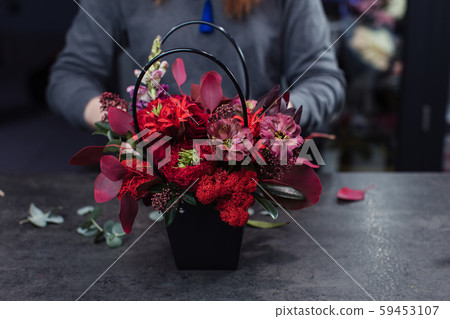 Beautiful bouquet of mixed flowers with peonies. The work of the florist. Flower delivery 59453107