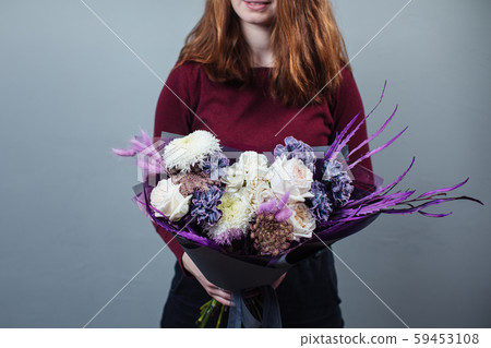 Beautiful bouquet of mixed flowers with peonies. The work of the florist. Flower delivery 59453108
