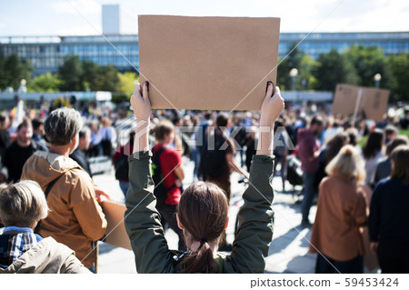 Rear view of people with placards and posters on global strike for climate change. 59453424