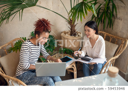 Entrepreneurs using calculator while making monthly report Entrepreneurs using calculator while making monthly report 59453946