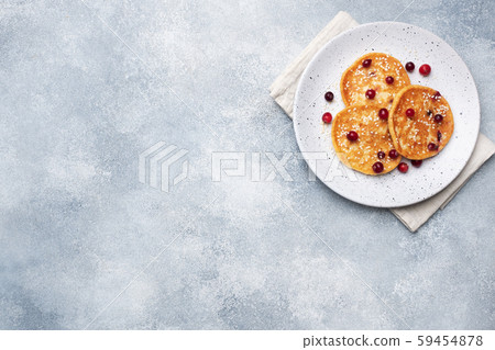 Cottage cheese pancakes with cranberries. Russian syrniki or sirniki, cottage cheese fritters or pancakes on the plate. Cottage cheese pancakes with cranberries. Russian syrniki or sirniki, cottage cheese fritters or pancakes on the plate. 59454878