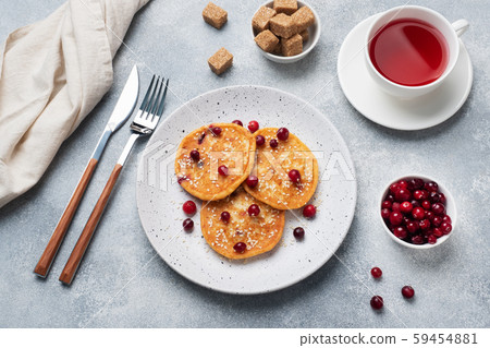 Cottage cheese pancakes with cranberries. Russian syrniki or sirniki, cottage cheese fritters or pancakes on the plate. Cottage cheese pancakes with cranberries. Russian syrniki or sirniki, cottage cheese fritters or pancakes on the plate. 59454881