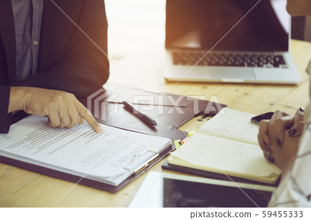 A businessman reading a business agreement before A businessman reading a business agreement before 59455333