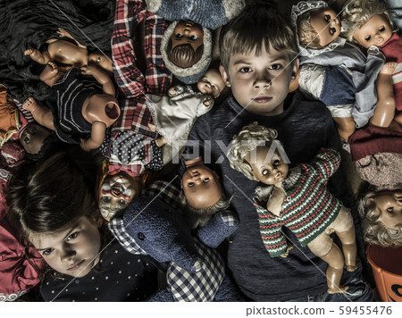 Scary children in a pile of creepy dolls 59455476