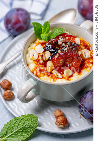Gluten-free millet porridge in a ceramic bowl. 59456538