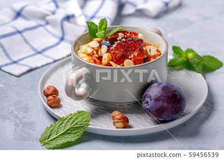 Organic millet porridge with caramelized plums. 59456539