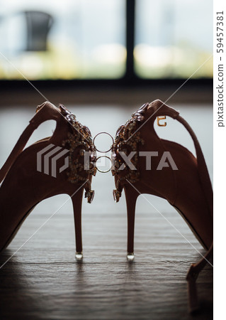 wedding rings on the bride shoes. Wedding. Decor. Bride shoes. 59457381