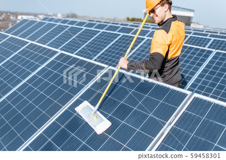 Workman cleaning solar panels Workman cleaning solar panels 59458301