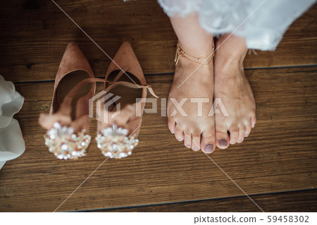 wedding concept. Shoes of the bride with a beautiful pattern of jewelry wedding concept. Shoes of the bride with a beautiful pattern of jewelry 59458302