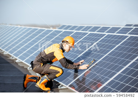 Worker installing solar panels 59458492
