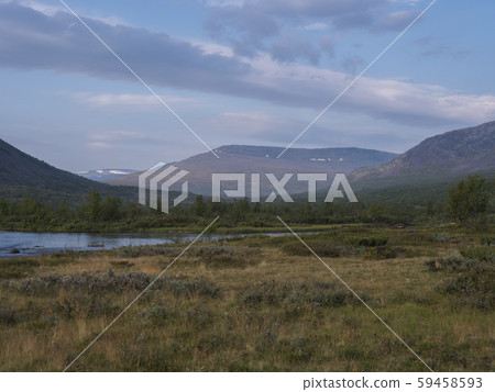 Beautiful wild Lapland nature landscape with blue Tjaktjajakka river, Kaitumjaure, birch tree forest 59458593