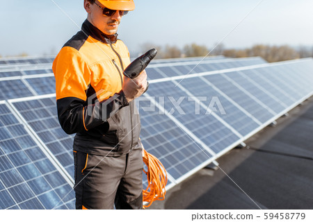 Well-equipped workman on a solar station 59458779