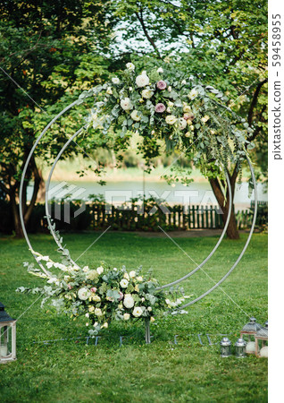 Arch for the wedding ceremony, decorated with cloth and flowers Arch for the wedding ceremony, decorated with cloth and flowers 59458955