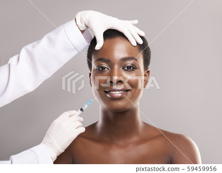 Young african woman getting beauty injection for face 59459956