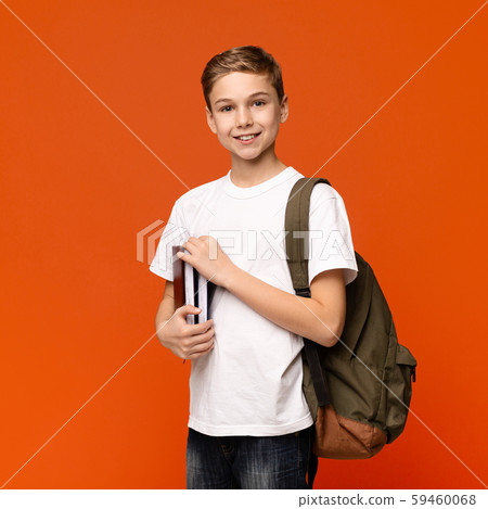 Teen boy ready for getting education, smiling with books and backpack Teen boy ready for getting education, smiling with books and backpack 59460068