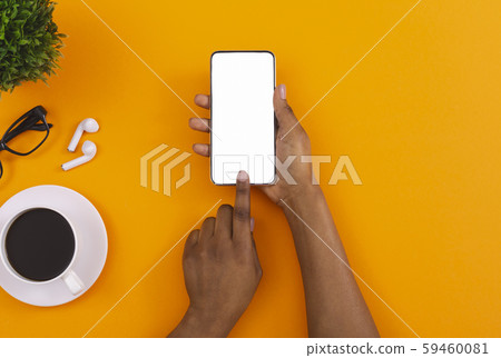 Black female using smartphone for listening music online in erphones 59460081