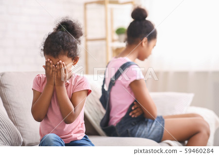 Little african girl crying after quarrel with her elder sister Little african girl crying after quarrel with her elder sister 59460284