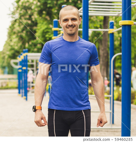 Man smiling and looking in camera at sports ground 59460285