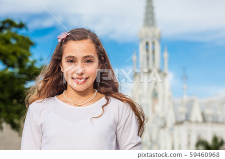 Girl at the River Boulevard in front of the famous gothic church of La Ermita in Cali Girl at the River Boulevard in front of the famous gothic church of La Ermita in Cali 59460968