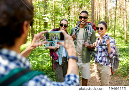 friends with backpacks being photographed on hike friends with backpacks being photographed on hike 59466355