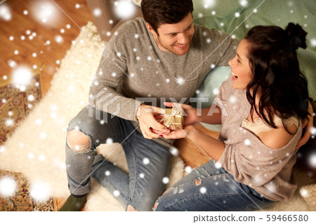 happy couple with gift box at home happy couple with gift box at home 59466580