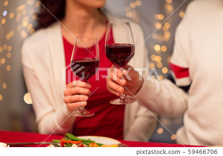 close up of couple drinking red wine on christmas 59466706