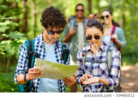 friends with map and backpacks hiking in forest friends with map and backpacks hiking in forest 59466812