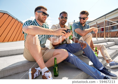 men with smartphone drinking beer on street men with smartphone drinking beer on street 59467213