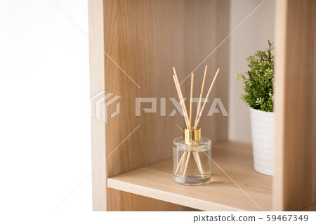 aroma reed diffuser on wooden shelf 59467349