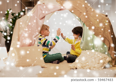 boys playing clapping game in kids tent at home boys playing clapping game in kids tent at home 59467483