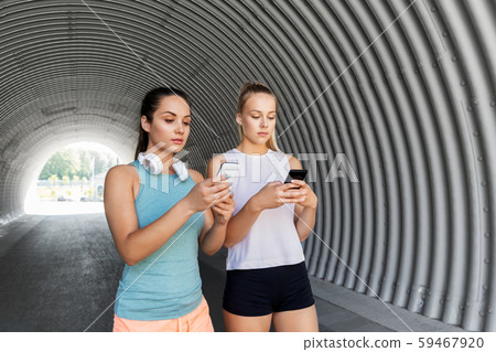 women or female friends with smartphones women or female friends with smartphones 59467920
