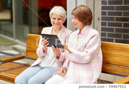 senior women with tablet computer in city senior women with tablet computer in city 59467952