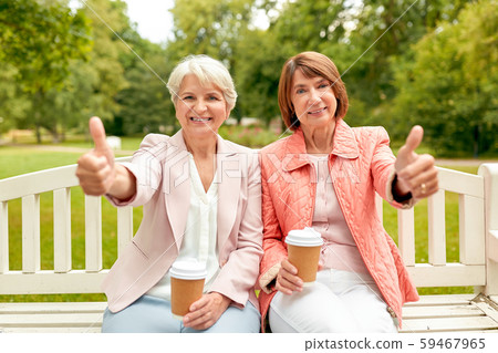 senior women with coffee showing thumbs up at park senior women with coffee showing thumbs up at park 59467965