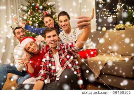 friends celebrating christmas and taking selfie friends celebrating christmas and taking selfie 59468101