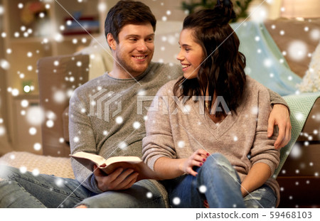 happy couple reading book at home happy couple reading book at home 59468103