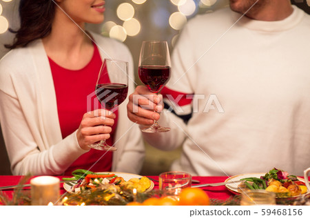 close up of couple drinking red wine on christmas 59468156