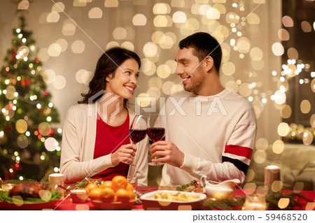 happy couple drinking red wine at christmas dinner 59468520