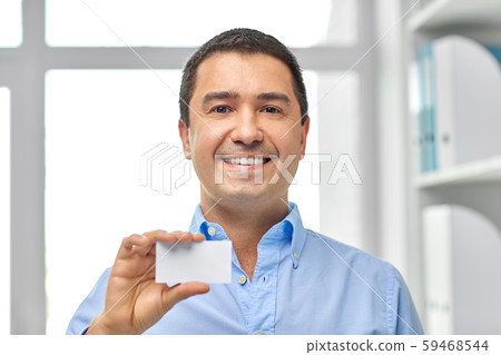smiling businessman with business card at office smiling businessman with business card at office 59468544